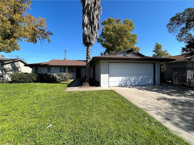 6917 Stillwater Way, Sacramento, CA 95828 - ranch-style house with a garage, stucco siding, fence, a front yard, and driveway