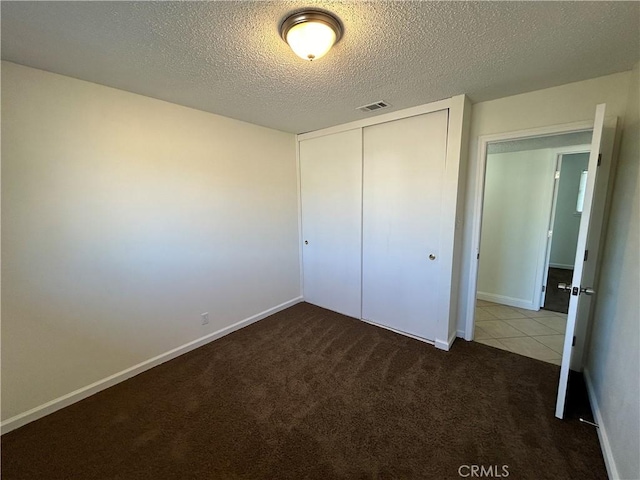 6917 Stillwater Way, Sacramento, CA 95828 - unfurnished bedroom with carpet flooring, a closet, a textured ceiling, and visible vents