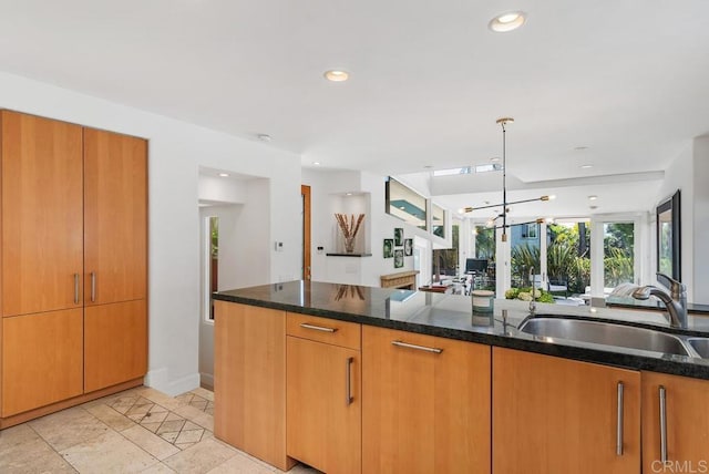 1407 Ocean, Del Mar, CA 92014 - kitchen with a sink, brown cabinets, dark stone counters, recessed lighting, and a notable chandelier