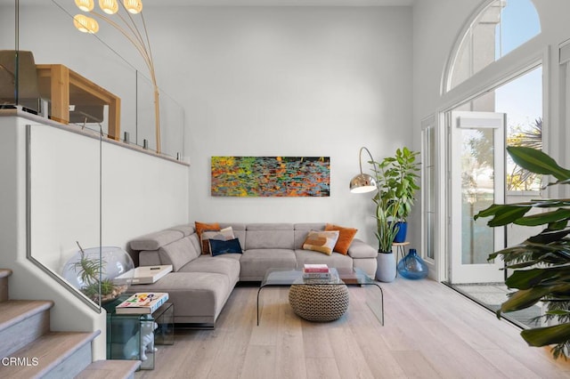 1323 Bayside Cir, Oxnard, CA 93035 - living area with plenty of natural light, a high ceiling, wood finished floors, and stairs