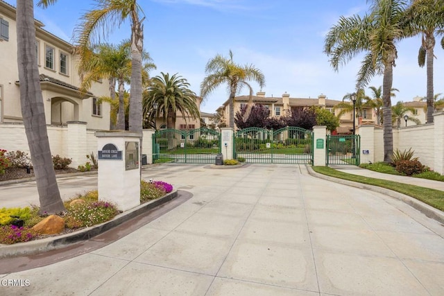 1323 Bayside Cir, Oxnard, CA 93035 - view of concrete road featuring a gate, curbs, a gated entry, sidewalks, and a residential view