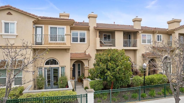 1323 Bayside Cir, Oxnard, CA 93035 - view of front facade with stucco siding, a tile roof, a fenced front yard, and a chimney