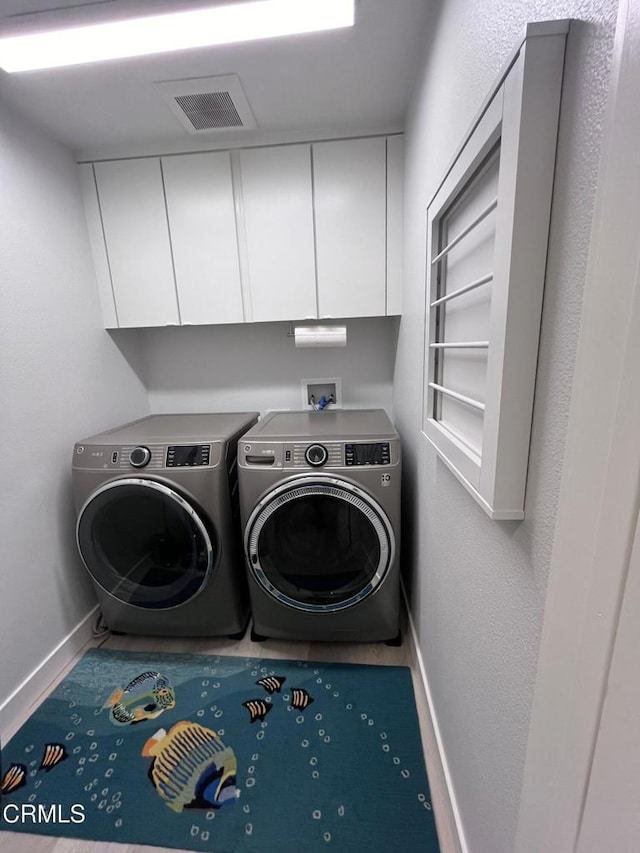 1323 Bayside Cir, Oxnard, CA 93035 - laundry area with independent washer and dryer, baseboards, and cabinet space