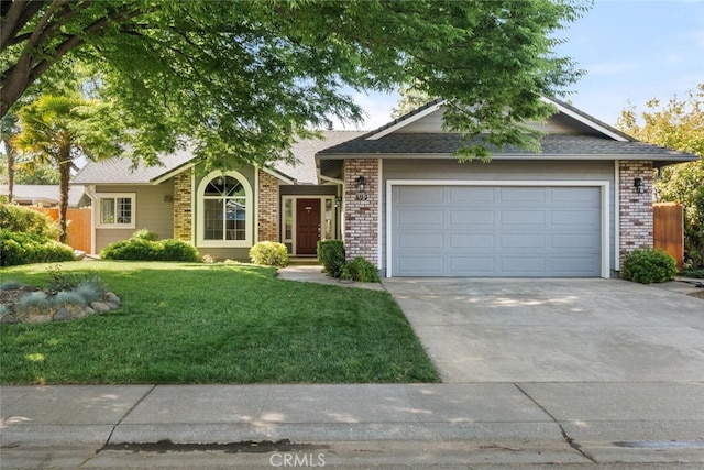 ranch-style house with roof with shingles, an attached garage, brick siding, concrete driveway, and a front lawn