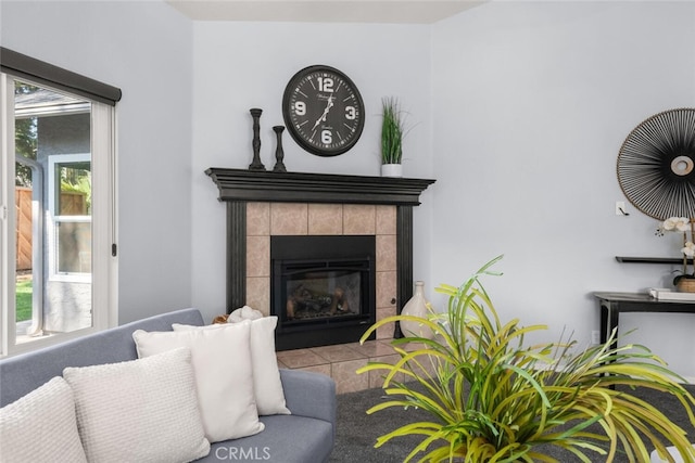 living room with a tile fireplace