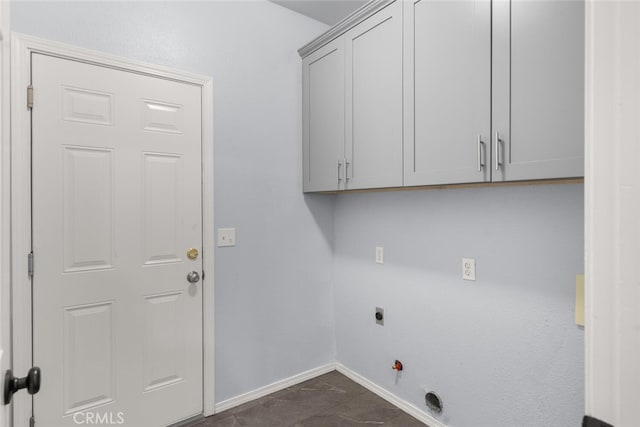 laundry room featuring cabinet space, baseboards, electric dryer hookup, and gas dryer hookup