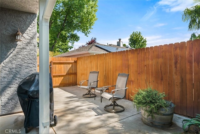 view of patio / terrace with a fenced backyard and a grill