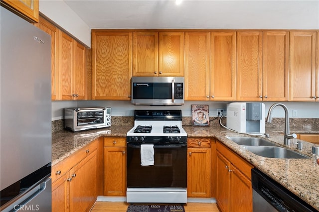 15796 Midwood Dr Unit 6, Granada Hills, CA 91344 - kitchen with stainless steel appliances, a sink, light stone counters, and brown cabinets