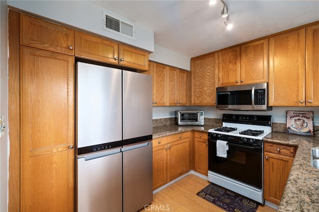 15796 Midwood Dr Unit 6, Granada Hills, CA 91344 - kitchen featuring stainless steel appliances, light wood finished floors, brown cabinets, and stone counters