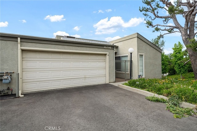 15796 Midwood Dr Unit 6, Granada Hills, CA 91344 - view of front of house with driveway, stucco siding, and a garage
