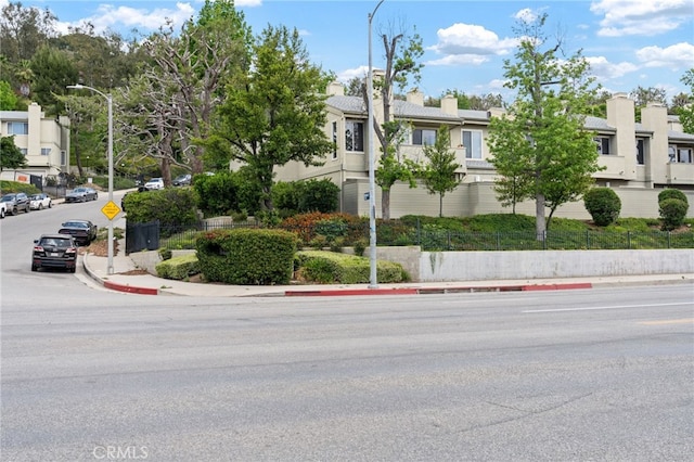 15796 Midwood Dr Unit 6, Granada Hills, CA 91344 - view of asphalt street featuring sidewalks, curbs, street lighting, traffic signs, and a residential view