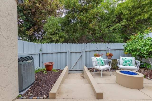 827 Del Mar Downs Rd Unit E, Solana Beach, CA 92075 - view of patio / terrace with central AC unit, a fenced backyard, and a gate