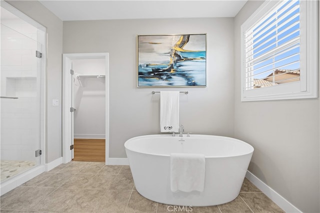 149 Fairgreen, Irvine, CA 92618 - bathroom featuring a stall shower, a spacious closet, a freestanding bath, baseboards, and tile patterned flooring