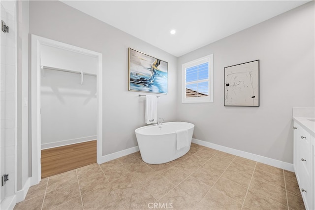 149 Fairgreen, Irvine, CA 92618 - bathroom with a spacious closet, vanity, a freestanding bath, baseboards, and recessed lighting