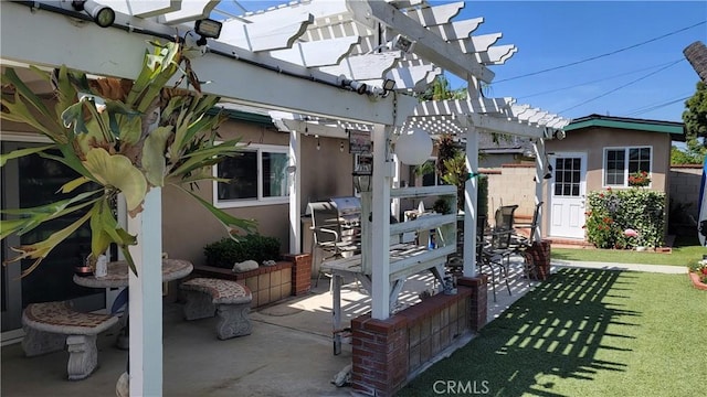 rear view of property with a pergola, a patio, stucco siding, and a yard