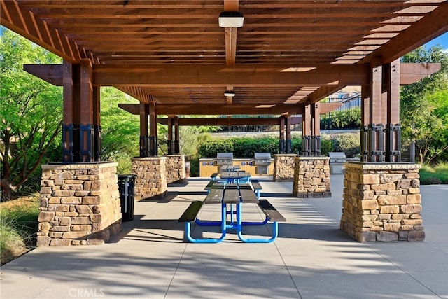 view of patio featuring area for grilling, grilling area, and a pergola