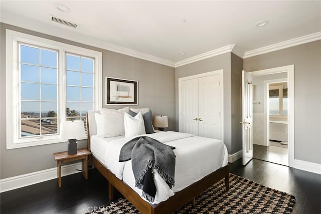 bedroom with a closet, visible vents, baseboards, ornamental molding, and dark wood-style floors