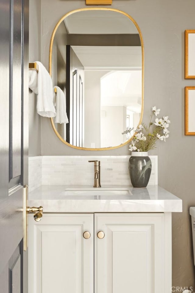 half bathroom with toilet and vanity