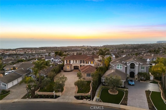 birds eye view of property featuring a water view and a residential view