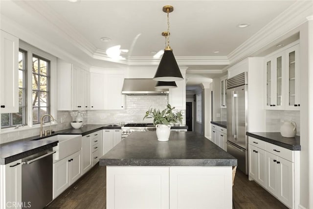 kitchen with dark countertops, appliances with stainless steel finishes, and a sink