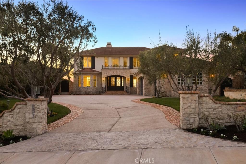 657 Via Faisan, San Clemente, CA 92673 - mediterranean / spanish home featuring stone siding, a chimney, and curved driveway