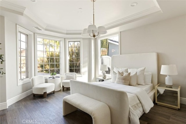 bedroom featuring ornamental molding, baseboards, visible vents, a raised ceiling, and a notable chandelier