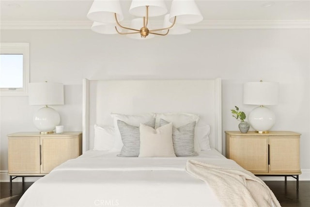 bedroom with ornamental molding and a notable chandelier