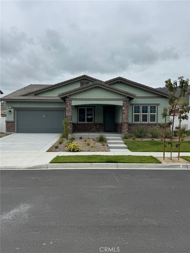 373 Wisteria St, Fillmore, CA 93015 - craftsman-style home with an attached garage, concrete driveway, and brick siding
