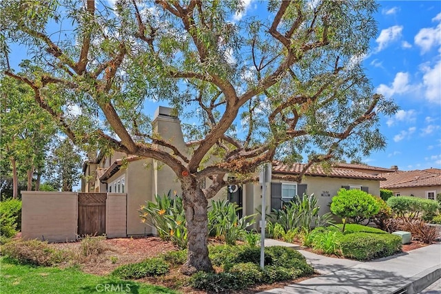 94 Paseo Vis, San Clemente, CA 92673 - view of side of home with a chimney, stucco siding, and fence