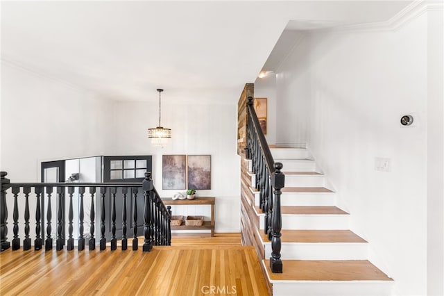 13402 Wheeler, North Tustin, CA 92705 - staircase featuring crown molding, wood finished floors, and a notable chandelier