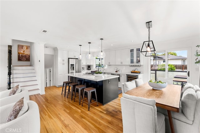 13402 Wheeler, North Tustin, CA 92705 - kitchen featuring light countertops, white cabinets, a kitchen bar, and a kitchen island