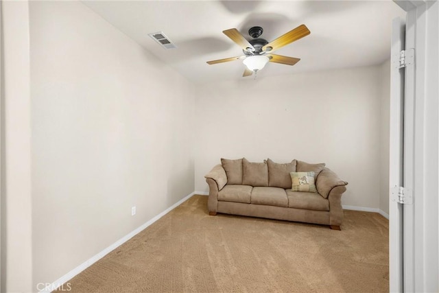 living area with light colored carpet, visible vents, baseboards, and a ceiling fan