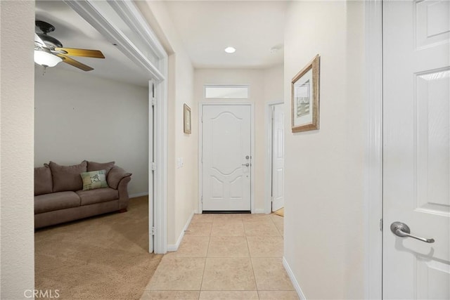 corridor featuring light colored carpet, light tile patterned floors, baseboards, and recessed lighting