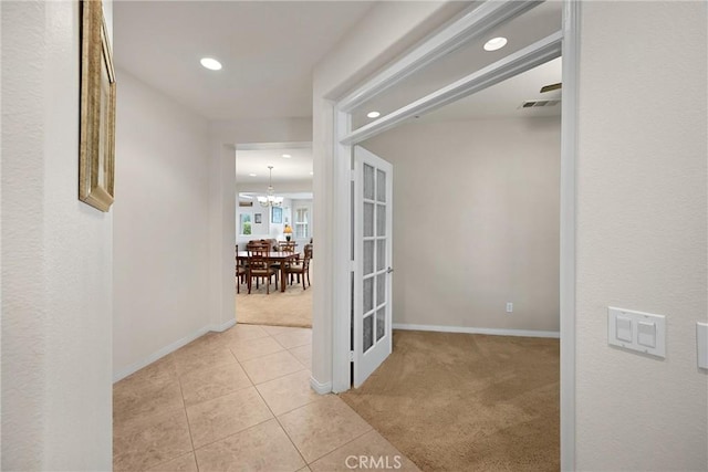 corridor with recessed lighting, light tile patterned floors, baseboards, visible vents, and light carpet