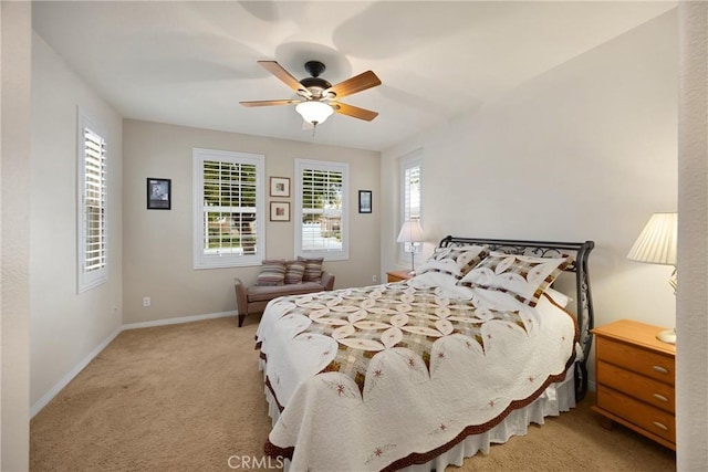 bedroom featuring baseboards, ceiling fan, and carpet