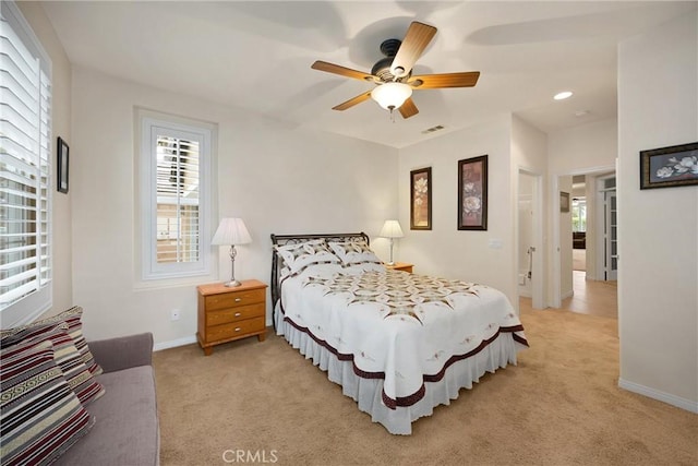 bedroom with baseboards, recessed lighting, light carpet, and visible vents