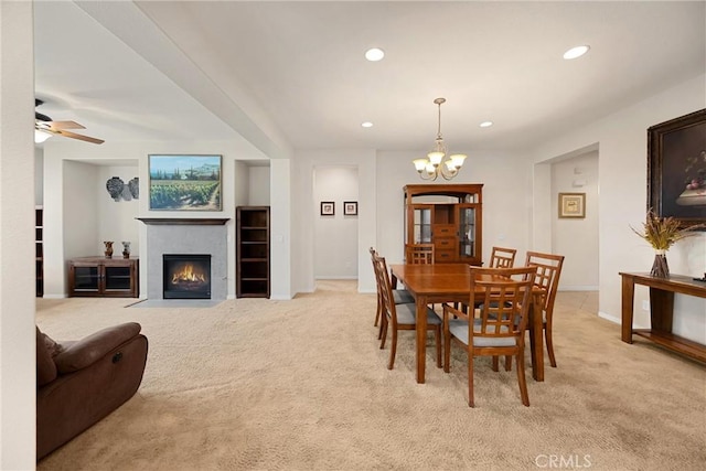dining room featuring light carpet, baseboards, a fireplace with flush hearth, and recessed lighting
