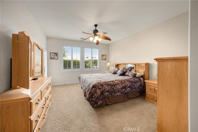 bedroom with baseboards, ceiling fan, and light colored carpet