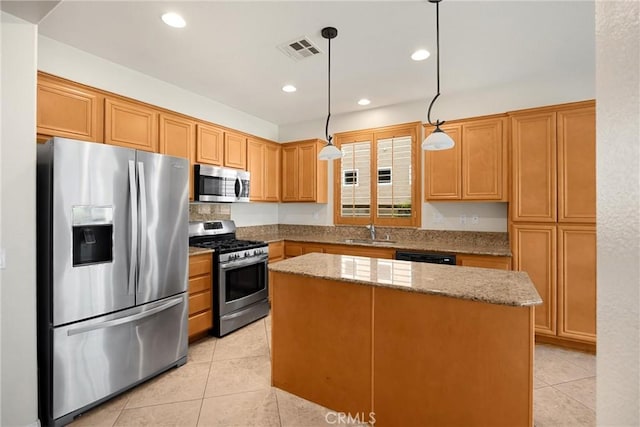 kitchen featuring light tile patterned floors, a center island, a sink, visible vents, and appliances with stainless steel finishes