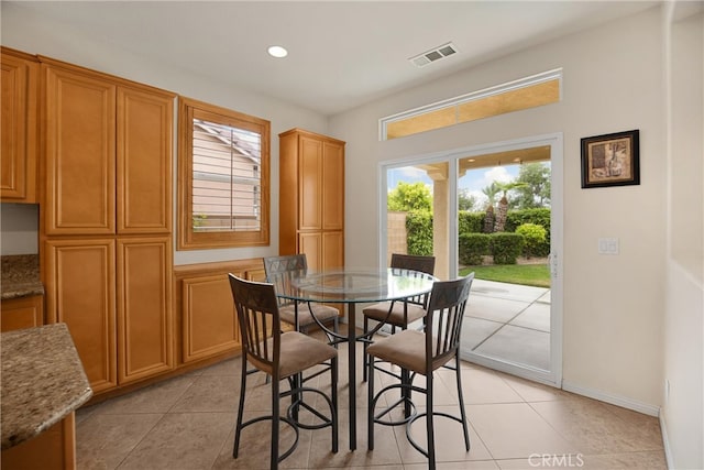 dining room featuring light tile patterned floors, visible vents, baseboards, and recessed lighting