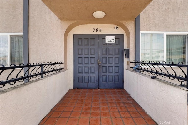 785 W 19th St Unit 10, San Pedro, CA 90731 - doorway to property with stucco siding and a balcony