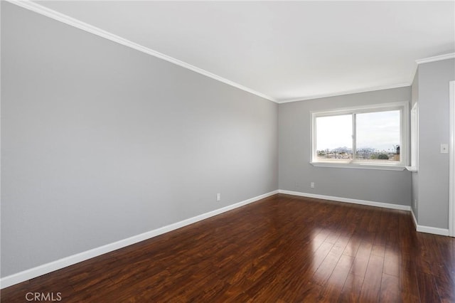 empty room featuring baseboards, dark wood-style flooring, and crown molding