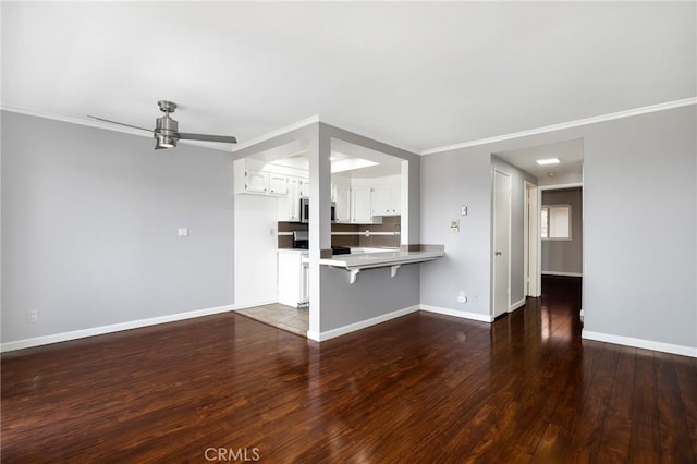 785 W 19th St Unit 10, San Pedro, CA 90731 - unfurnished living room featuring ceiling fan, dark wood-type flooring, baseboards, and crown molding