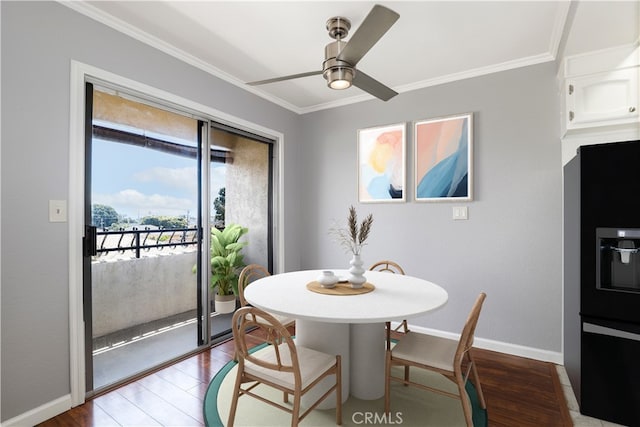 dining room with crown molding, baseboards, wood finished floors, and a ceiling fan