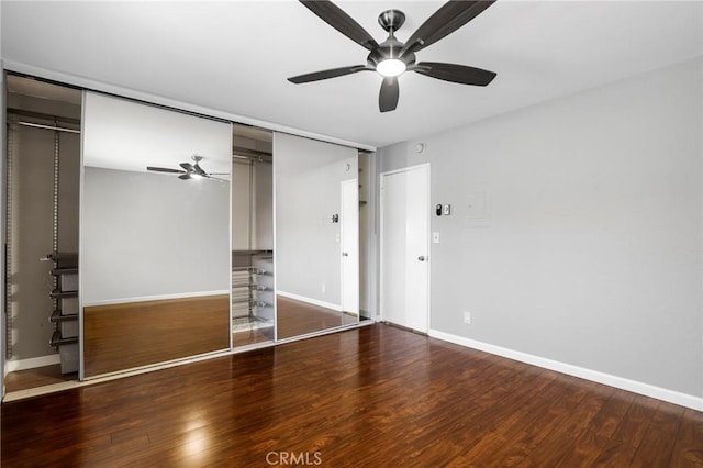 unfurnished bedroom with ceiling fan, a closet, baseboards, and wood finished floors