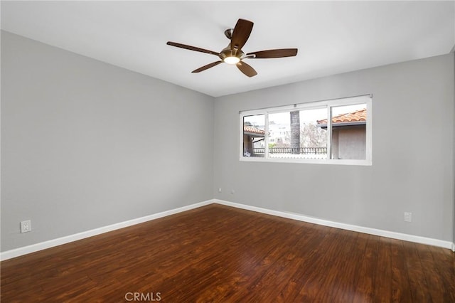 unfurnished room with baseboards, a ceiling fan, and wood finished floors