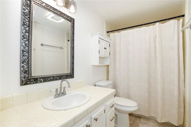 bathroom with vanity, toilet, and tile patterned floors