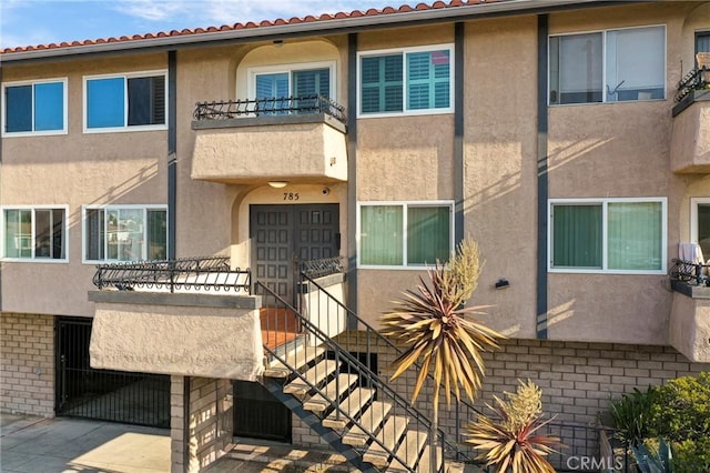 785 W 19th St Unit 10, San Pedro, CA 90731 - back of house with stucco siding, a balcony, and stairway