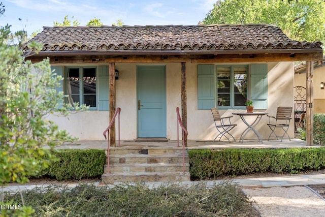 3325 Figueroa Mountain Rd, Los Olivos, CA 93441 - view of front of house with a porch, stucco siding, and a tiled roof