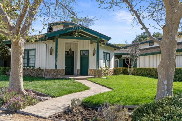 3325 Figueroa Mountain Rd, Los Olivos, CA 93441 - bungalow-style house featuring a front lawn and stone siding